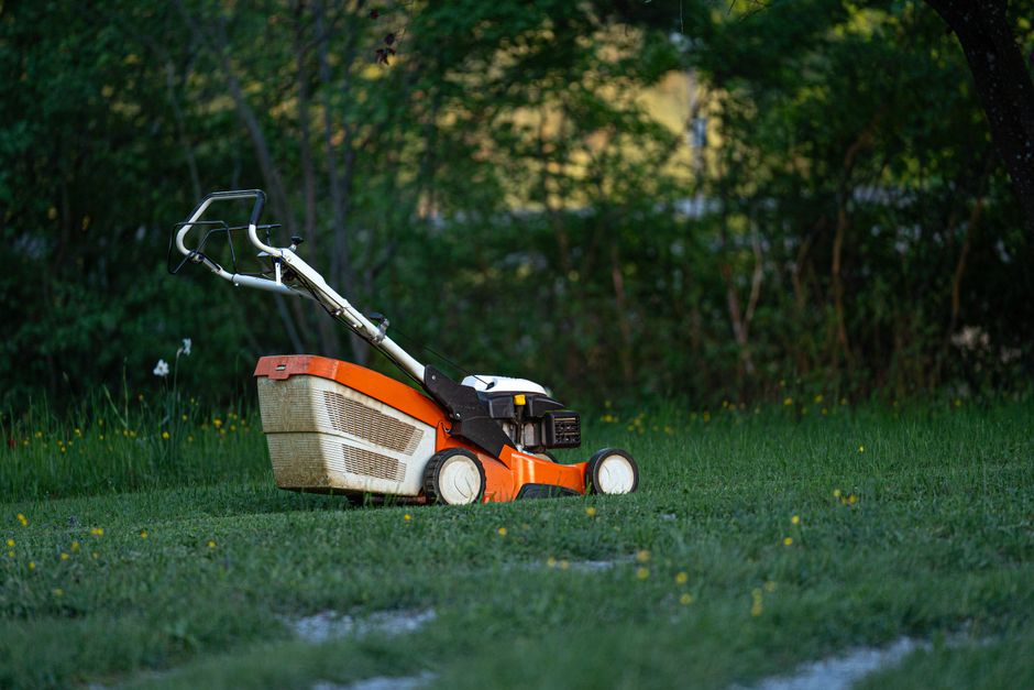Professional pushing a lawn mower
