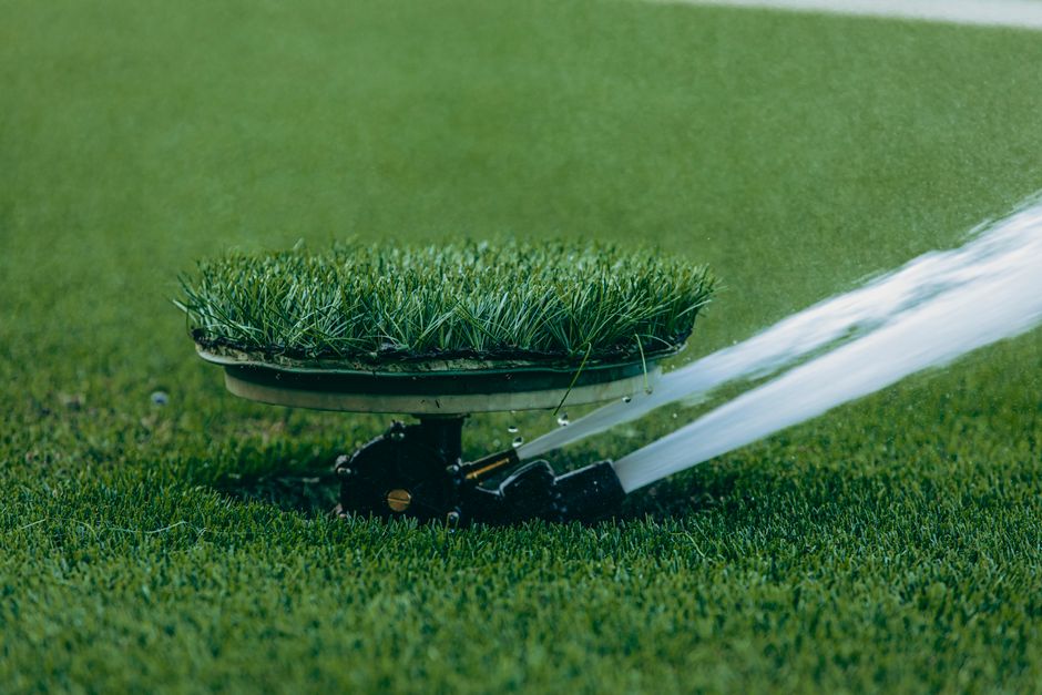 Lawn sprinkler watering green grass